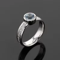 White gold ring with a Blue Topas and diamonds set on the shank