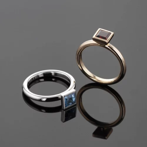 White gold and Blue Topas ring and rose gold and Garnet ring