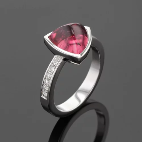 White gold ring with diamonds and a trillion shaped Pink Tourmaline cabochon