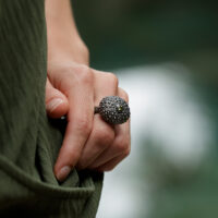 large sea urchin ring in black silver with a peridot stone