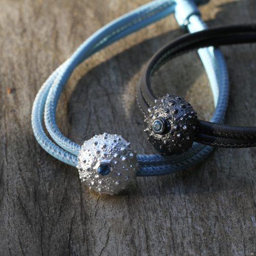 Sea urchin element in silver with a Blue stone on a leather bracelet