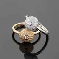 Delicate and small sea urchin rings in white and rose gold with diamonds