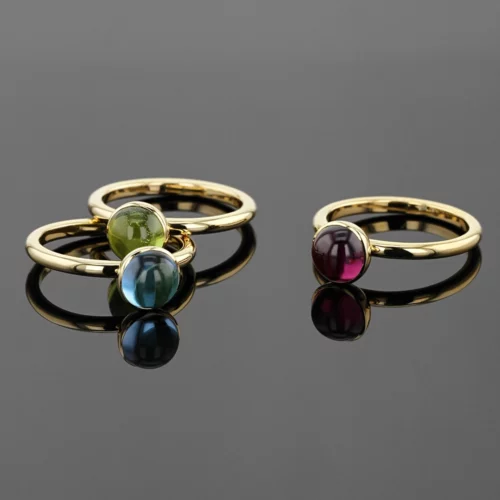 Yellow gold rings with Peridot, Blue Topas and Rhodolite cabochons