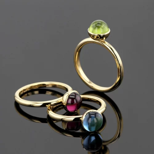 Yellow gold rings with Peridot, Blue Topas and Rhodolite cabochons