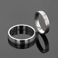 Simple wedding bands in white gold with a fine line seperating a polished side and a matted side of each ring.