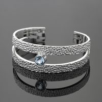 Bangle in silver with a rock texture and Blue Topas stone.