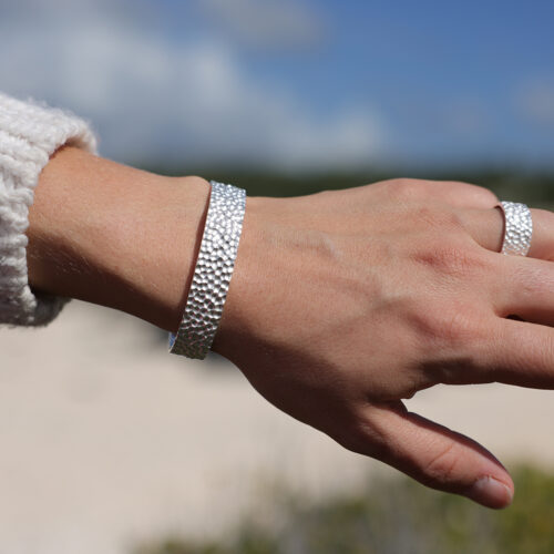 Wide bangle in silver with a rock texture