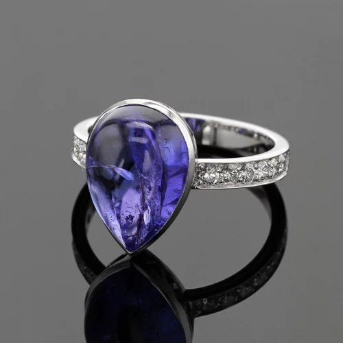 18ct white gold ring with diamonds on its shank and a large tear dropped Tanzanite cabochon