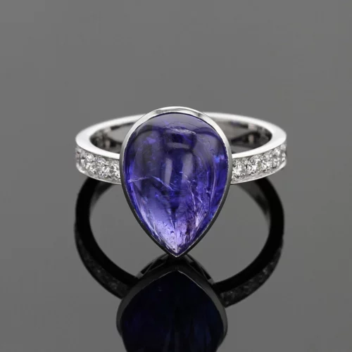 18ct white gold ring with diamonds on its shank and a large tear dropped Tanzanite cabochon