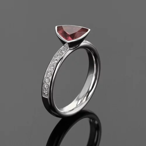 18ct white gold ring with diamonds on the side and a triangular shaped Pink Tourmaline