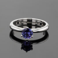 Classic polished white gold ring with a round Tanzanite