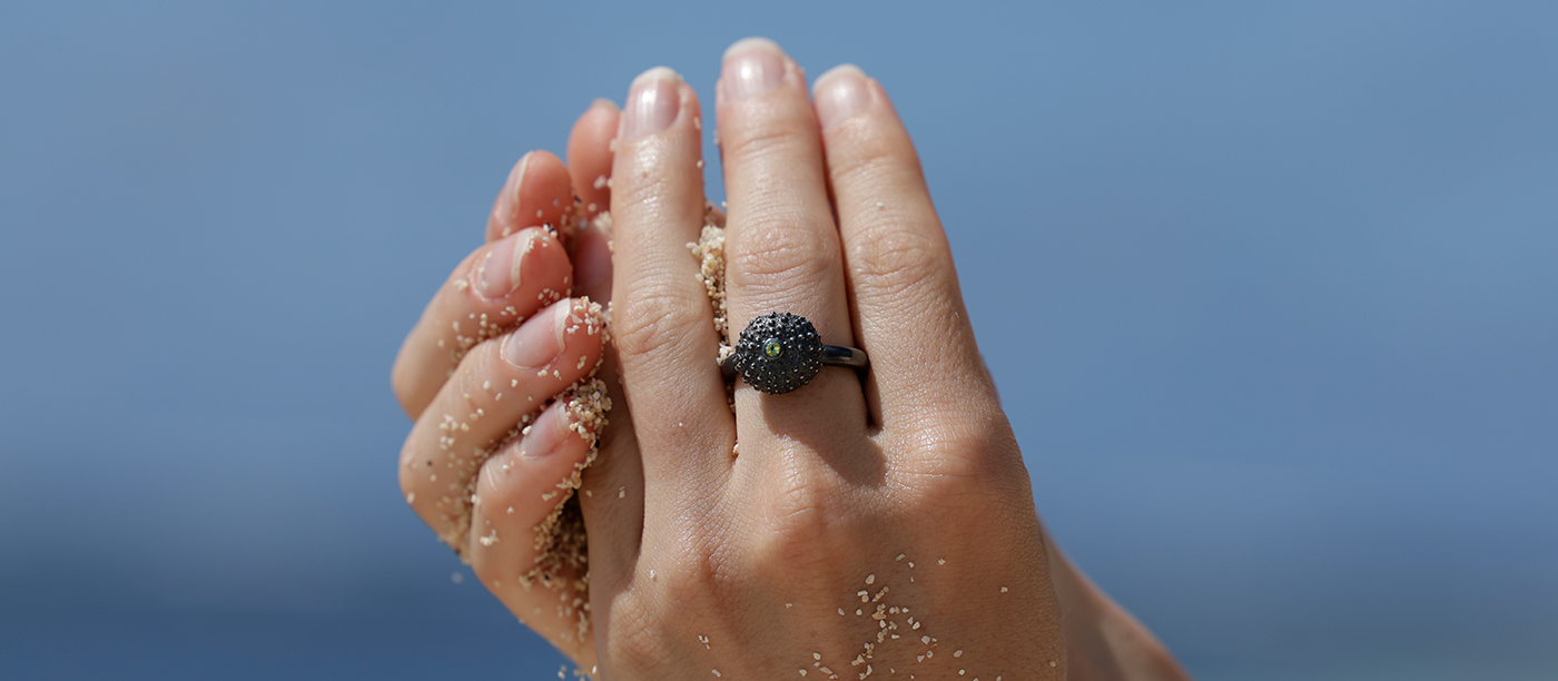 Oxidised silver ring with a tiny sea urchin element and Peridot