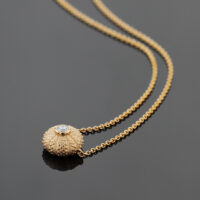 delicate sea urchin collier in 18ct rose gold with a diamond at its center