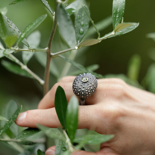 large sea urchin ring in black silver with a peridot stone