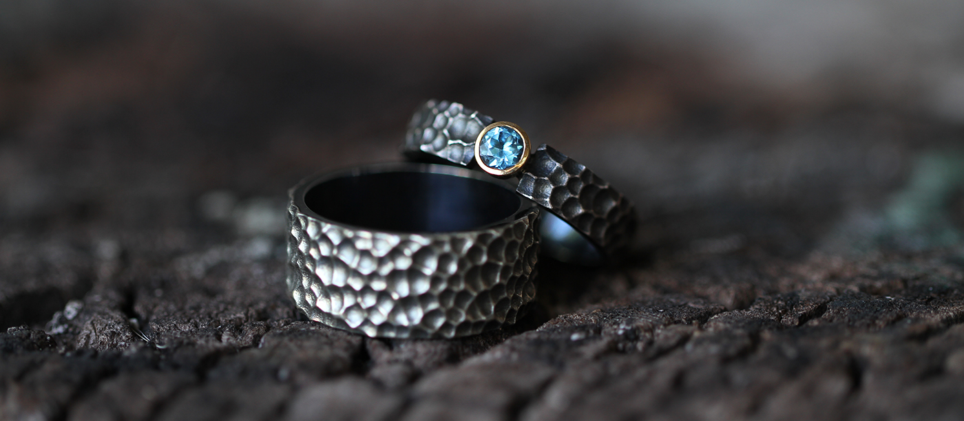 Oxidised silver rings with a lava rock texture and Blue Topas stone