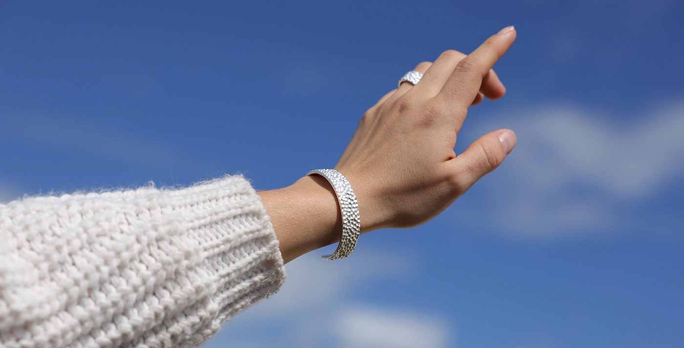 Silver bangle with a rock texture