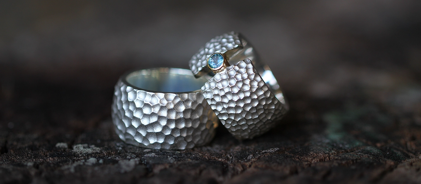 Silver rings with a lava rock texture and Blue Topas