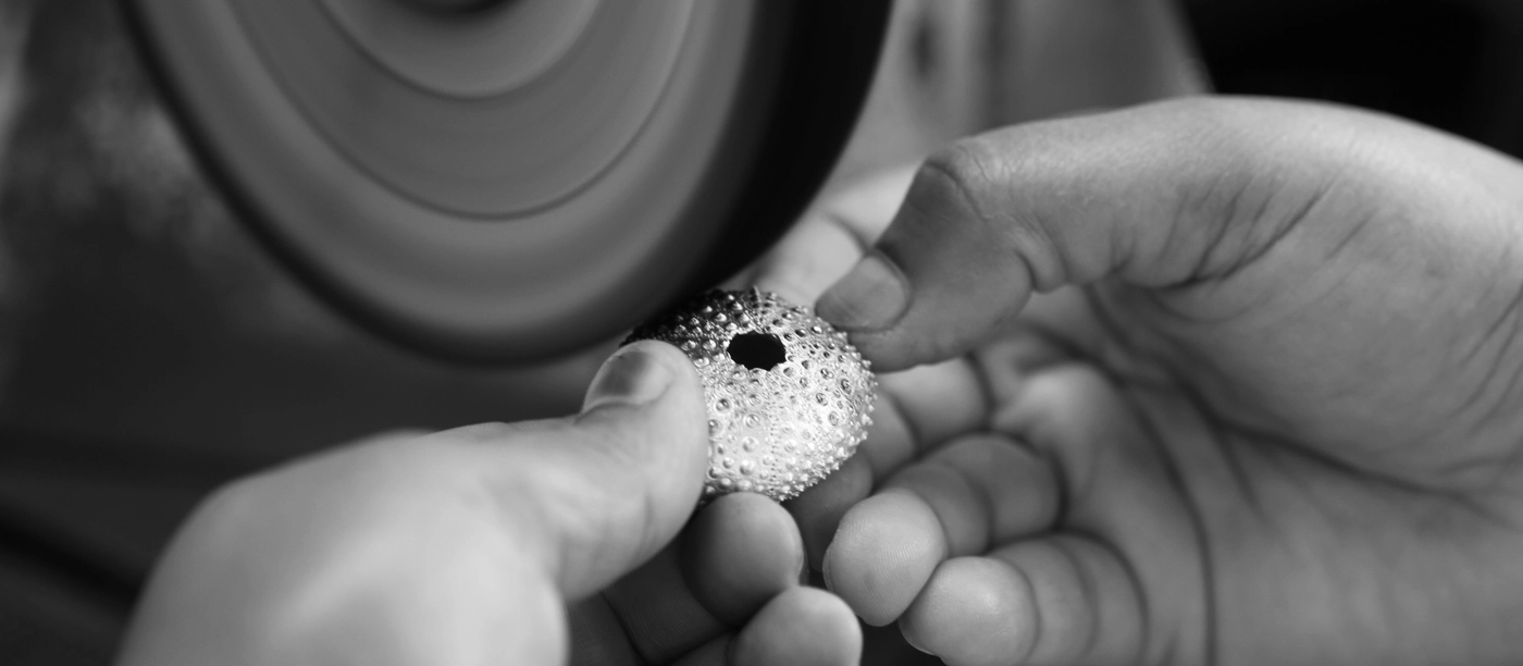 Polishing a sea urchin pendant