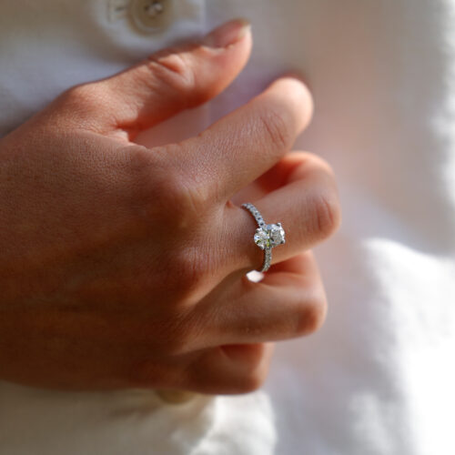 1.55ct oval shaped lab grown diamond ring in white gold with diamonds on the band.
