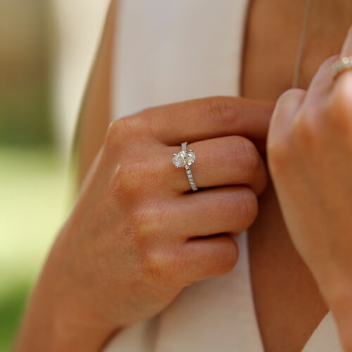 1.55ct oval shaped lab grown diamond ring in white gold with diamonds on the band.