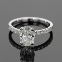 1.55ct oval shaped lab grown diamond ring in white gold with diamonds on the band.