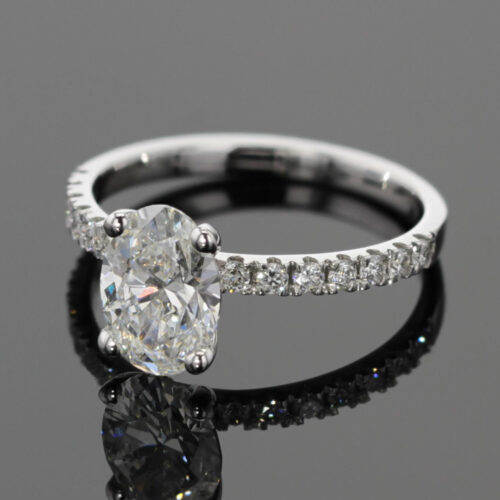 1.55ct oval shaped lab grown diamond ring in white gold with diamonds on the band.