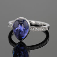 Tear drop Tanzanite cabochon set in a white gold ring with diamonds