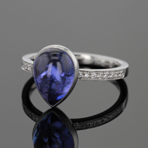 Tear drop Tanzanite cabochon set in a white gold ring with diamonds