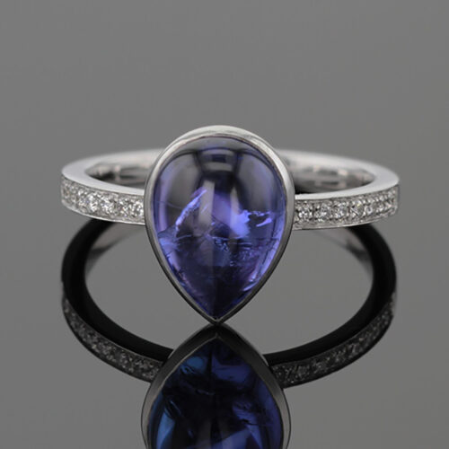 Tear drop Tanzanite cabochon set in a white gold ring with diamonds